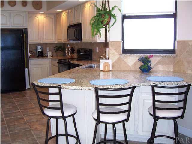 kitchen counter with bar stools